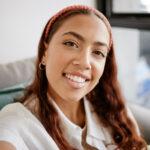 Woman sitting on couch smiling