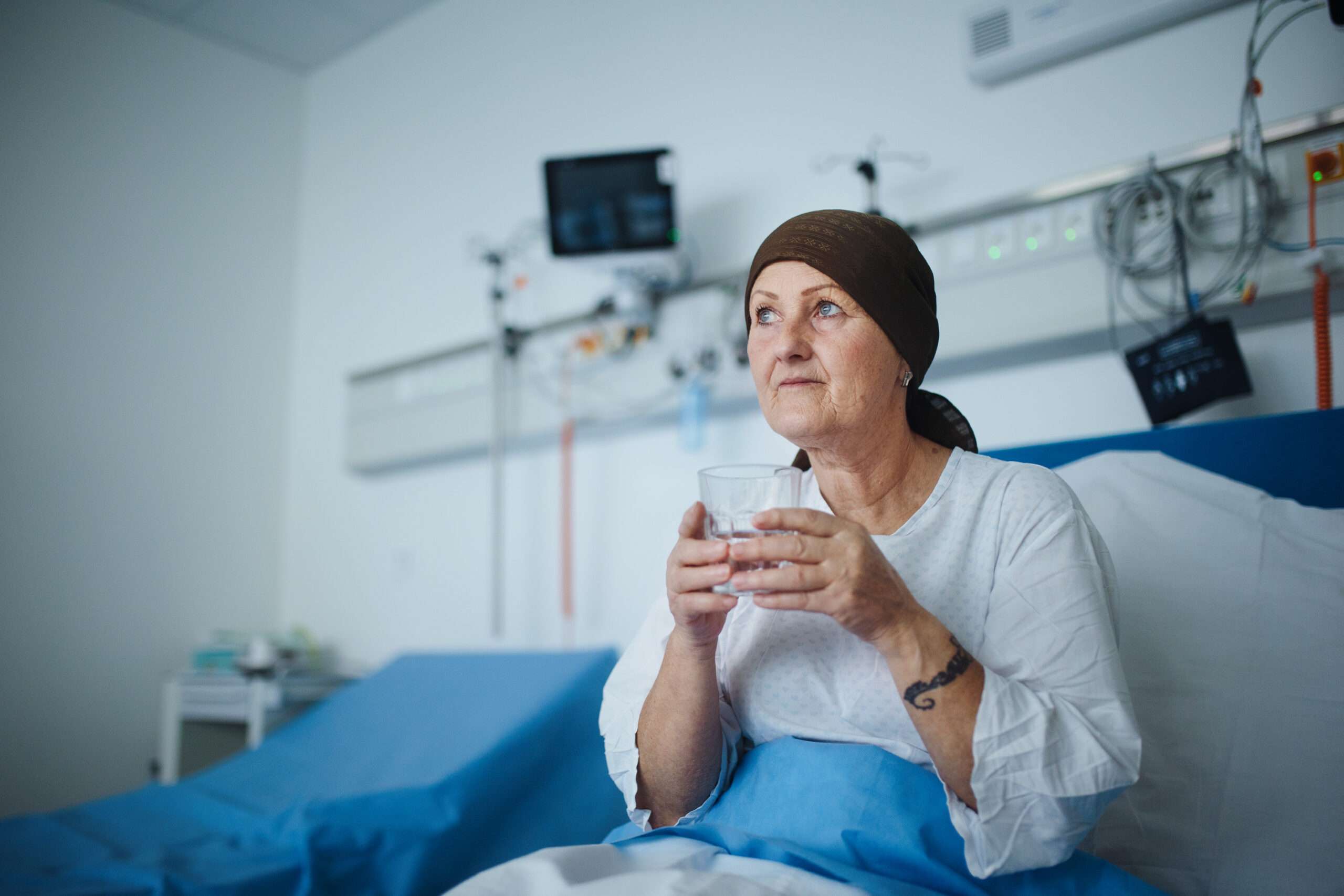 Senior woman sitting in hospital room, life insurance for cancer patients article