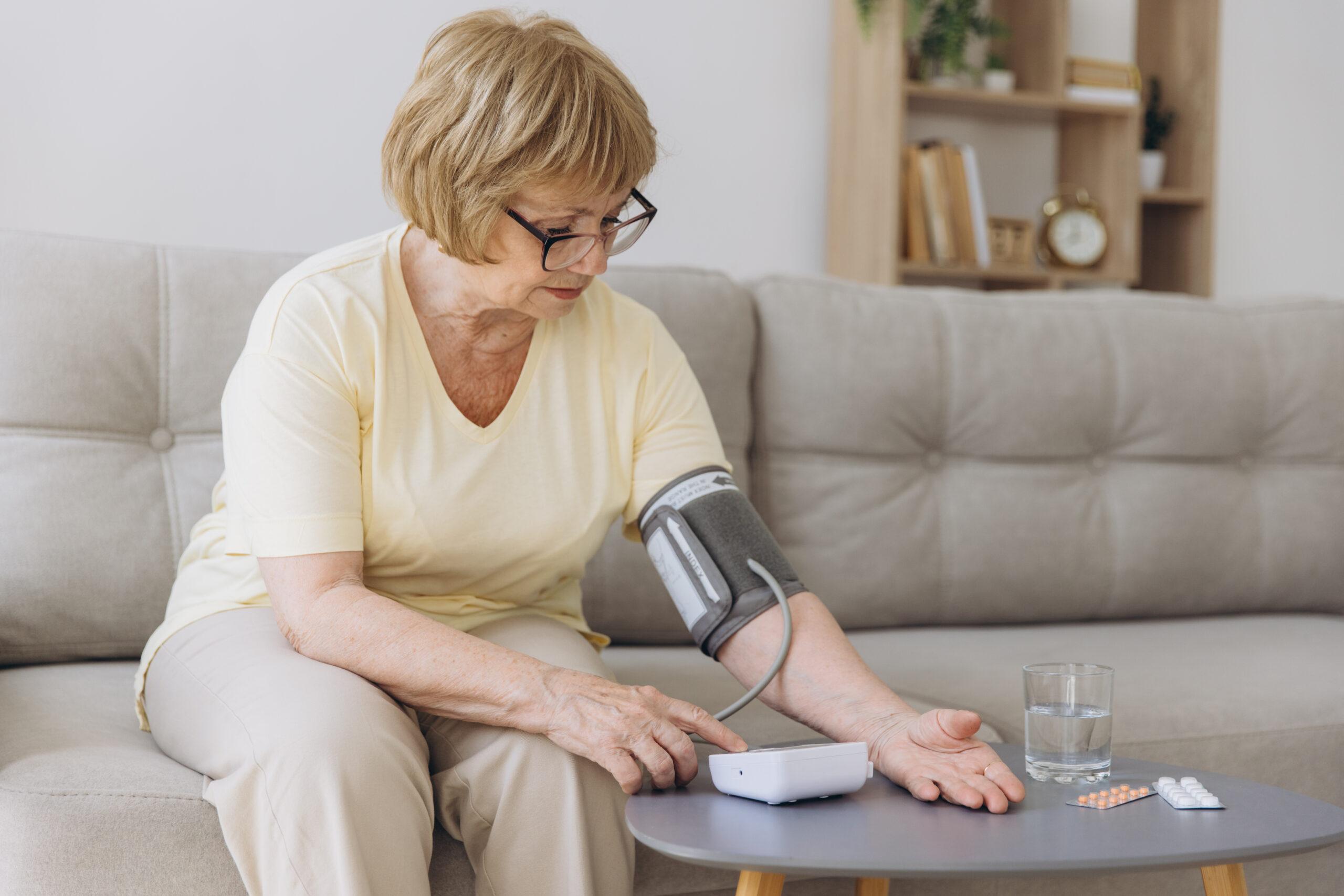 Senior woman measuring blood pressure