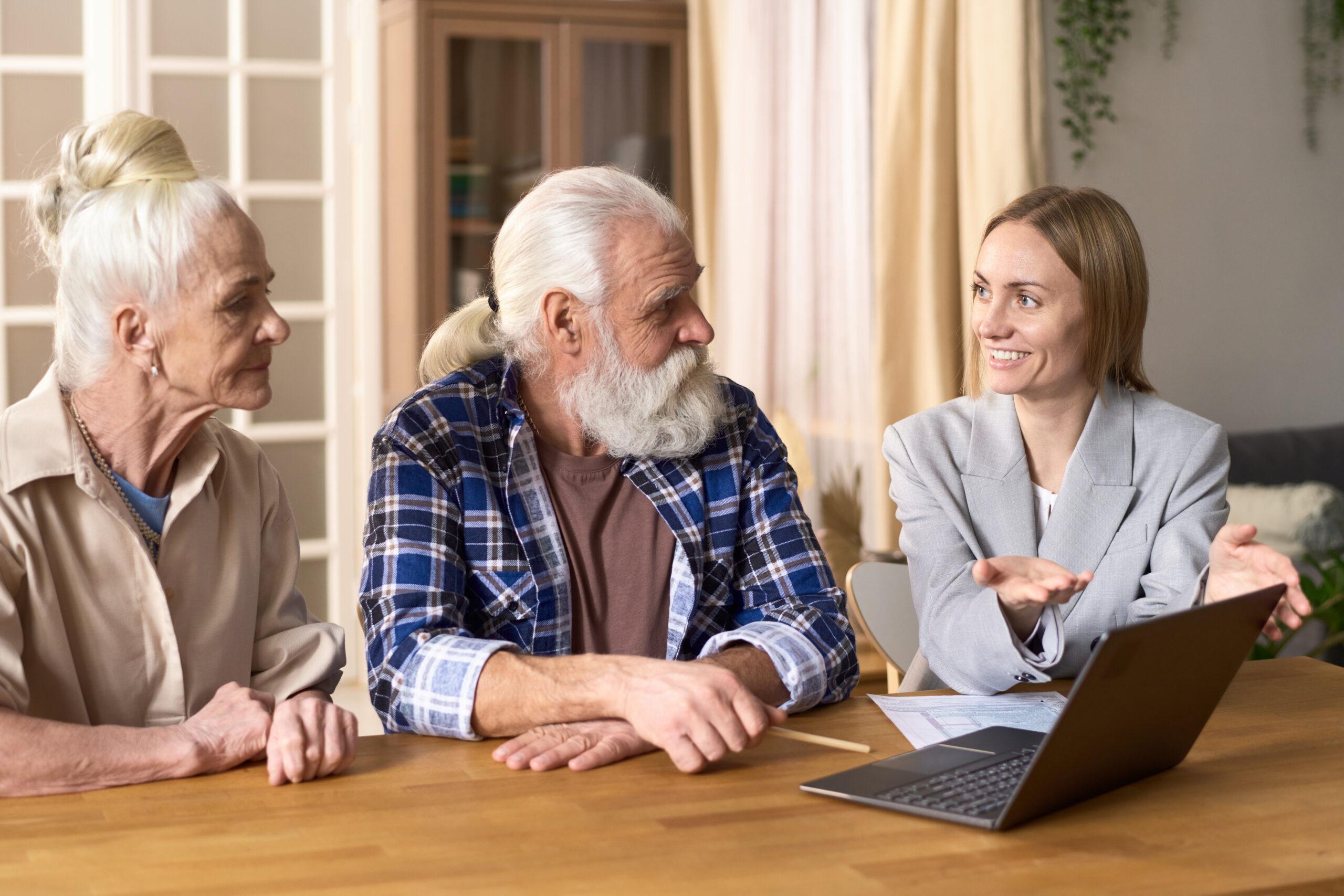 Consultant speaks with elderly couple about insurance options