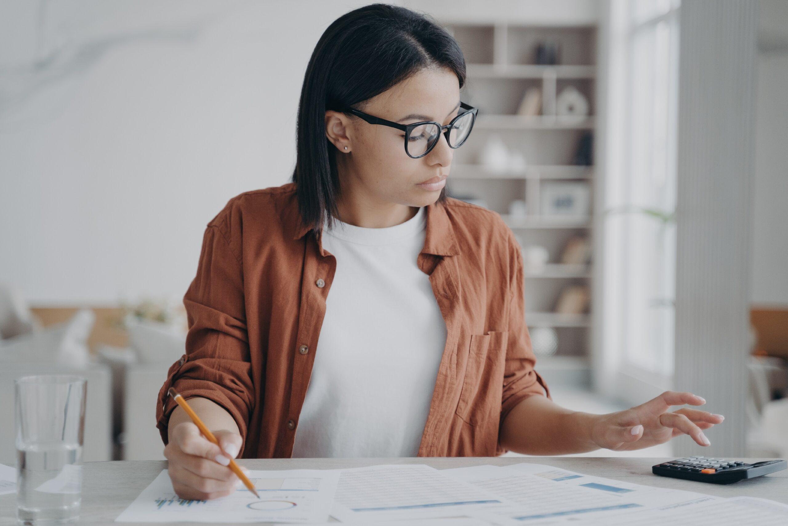 A businesswoman working on finances at home.