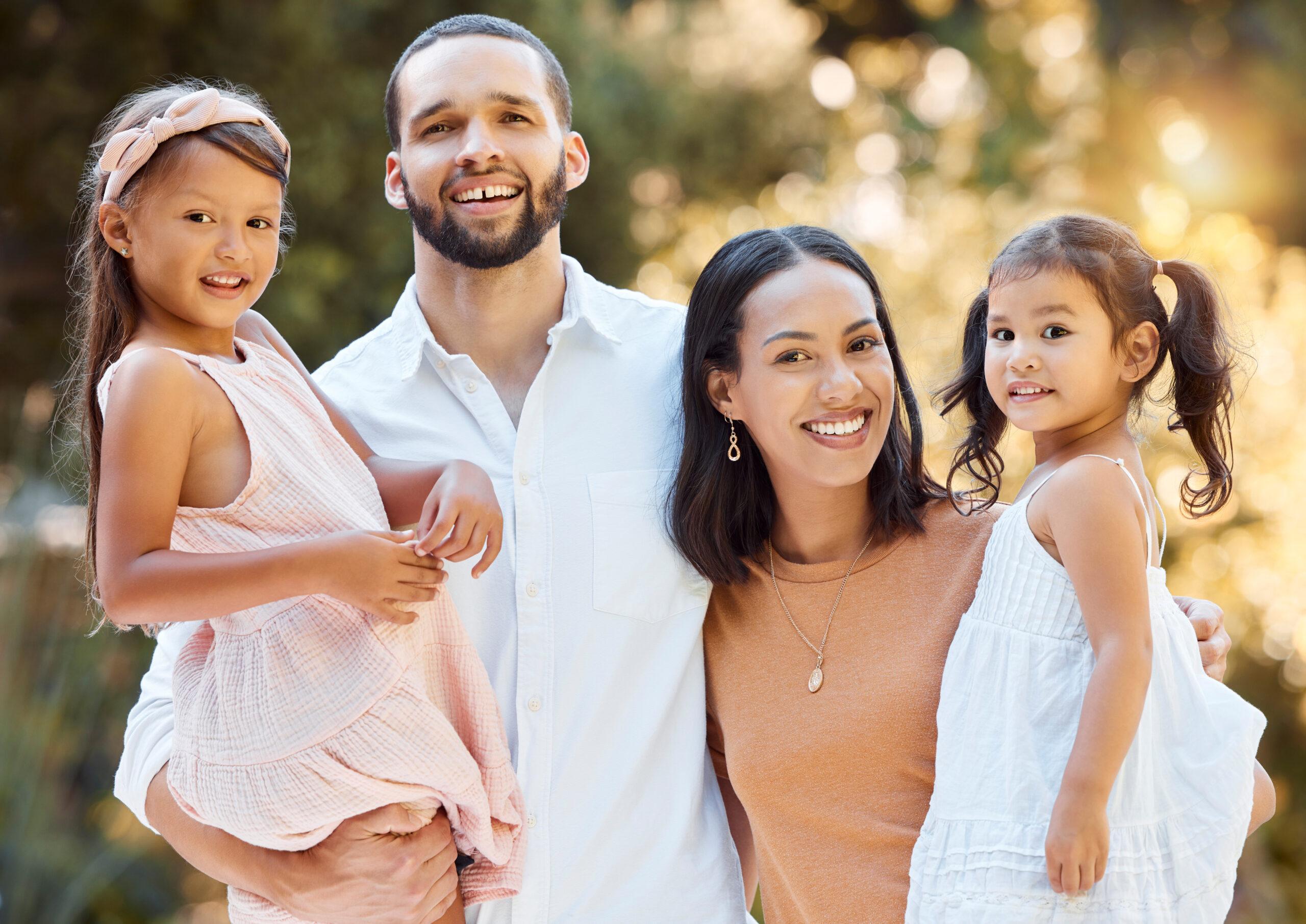 Family portrait with a couple and their kids bonding in a garden.