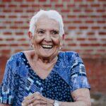 portrait of old lady in her 80s laughing happily