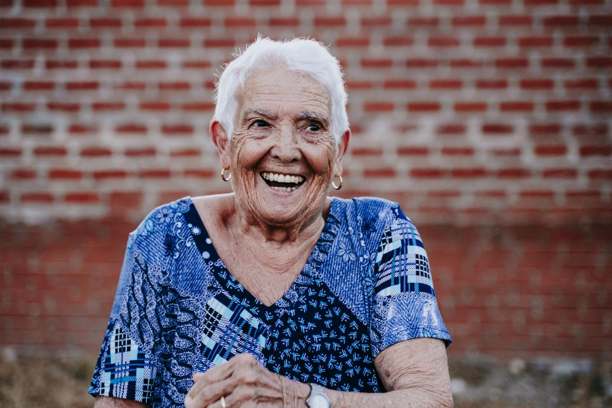 portrait of old lady in her 80s laughing happily