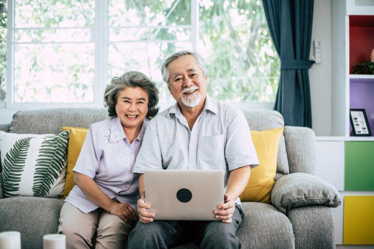 Senior couple talking with laptop computer