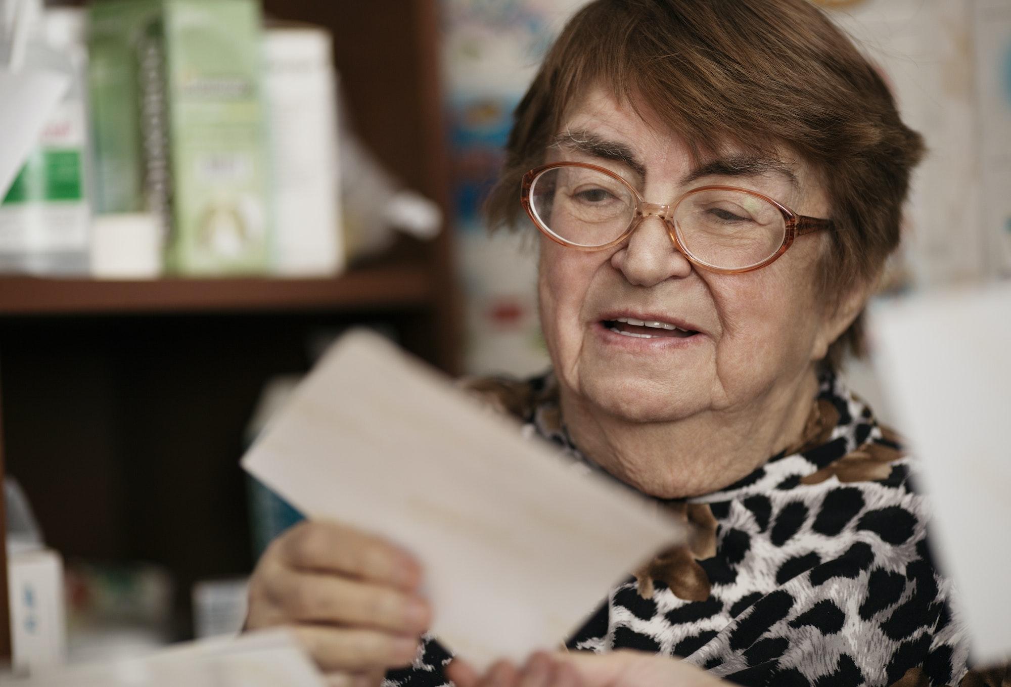 Elderly woman reading a letter