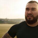 Young bearded man portrait outdoors in the mountains