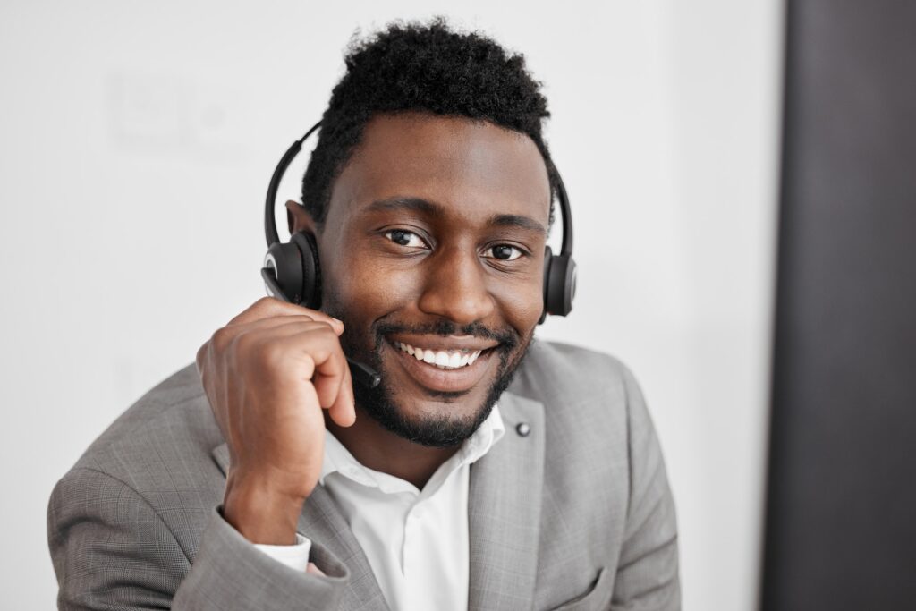 Call center, black man and contact us worker in crm customer service, consulting and sales telemark