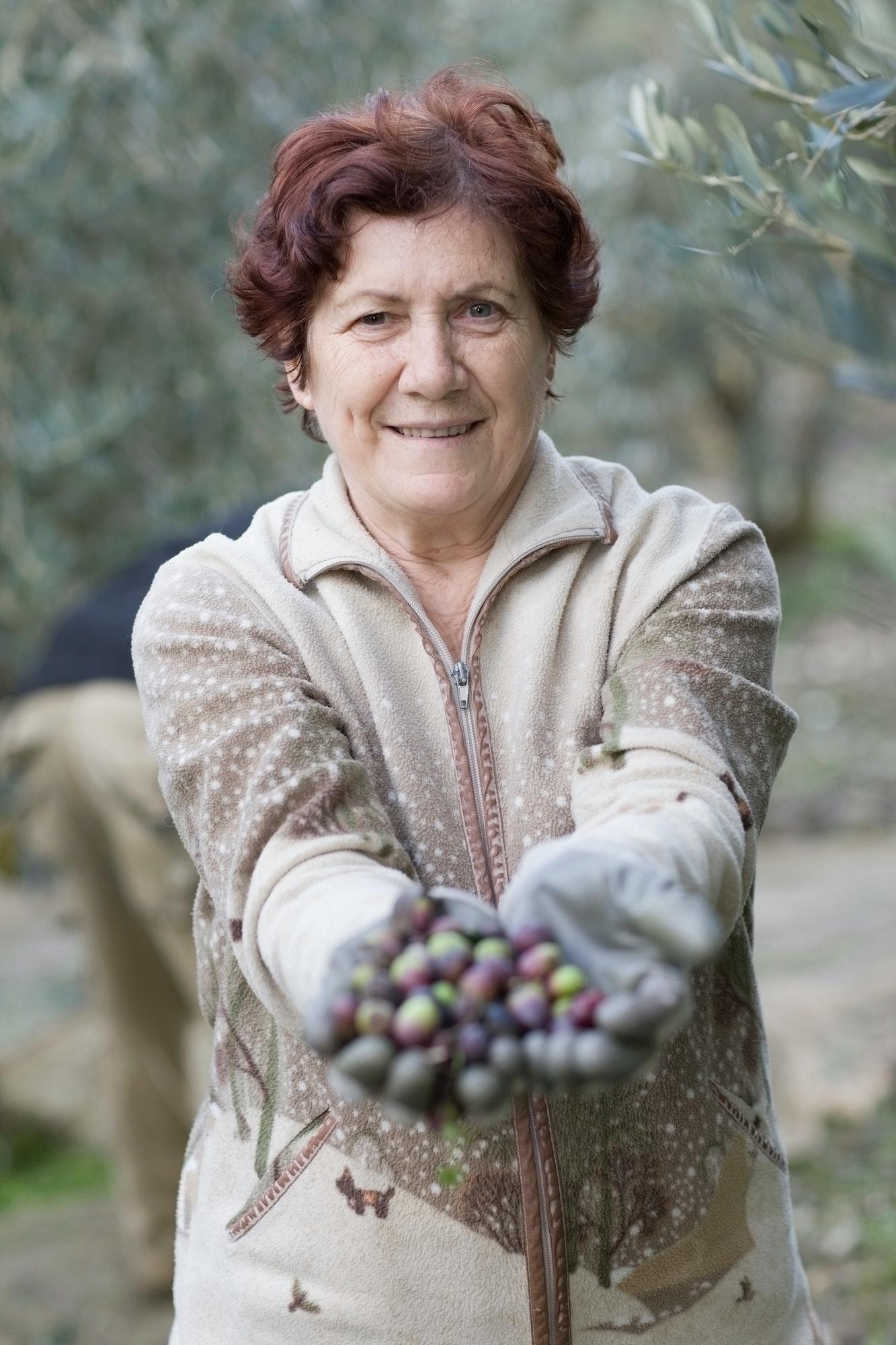 Older woman with olives