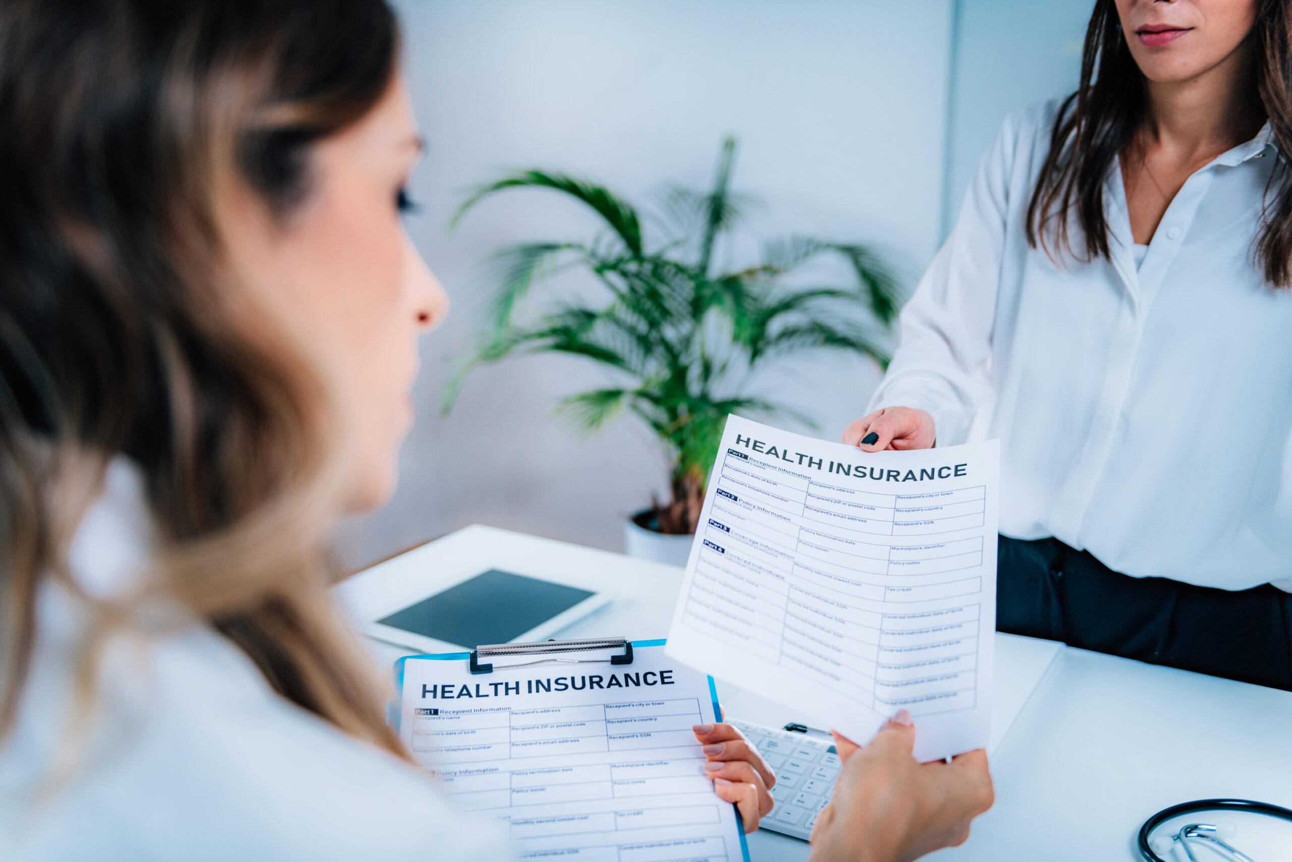 Woman Signing Health Insurance Policy