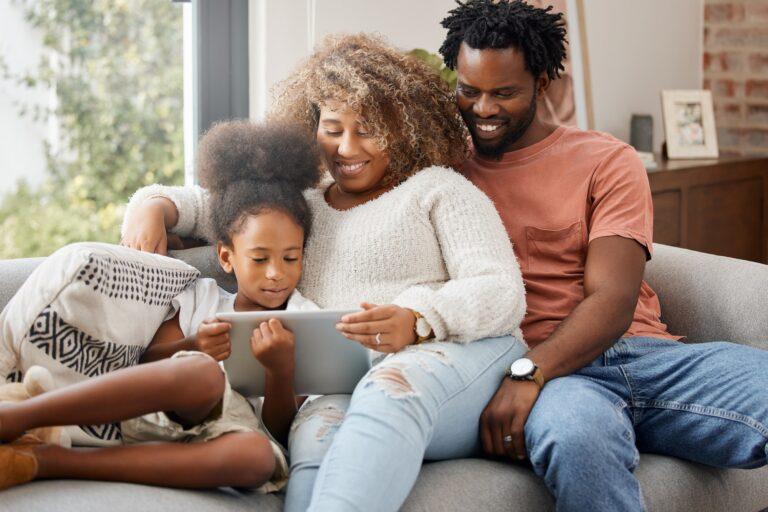 Shot of a young family spending time together and using a digital tablet at home