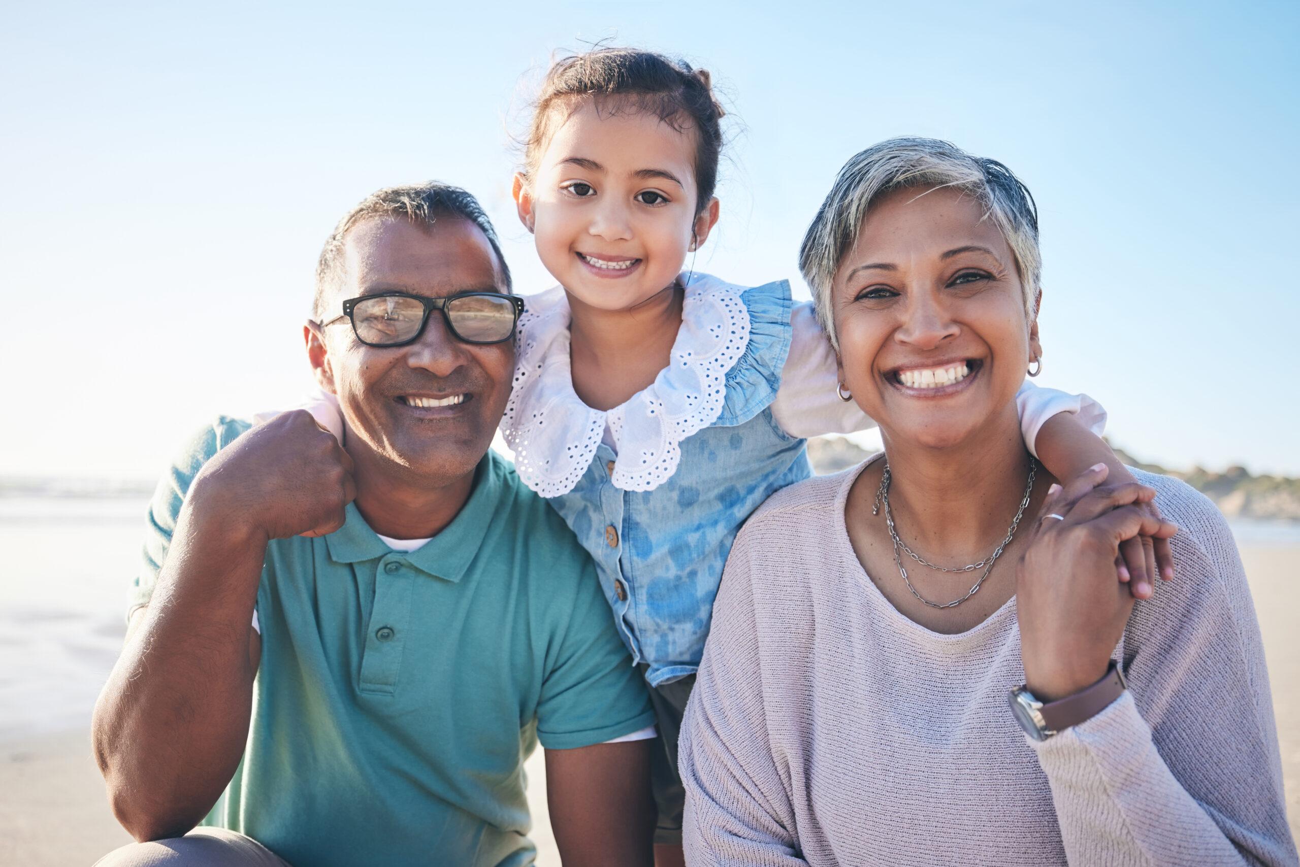 Grandparents and grandchild on the beach