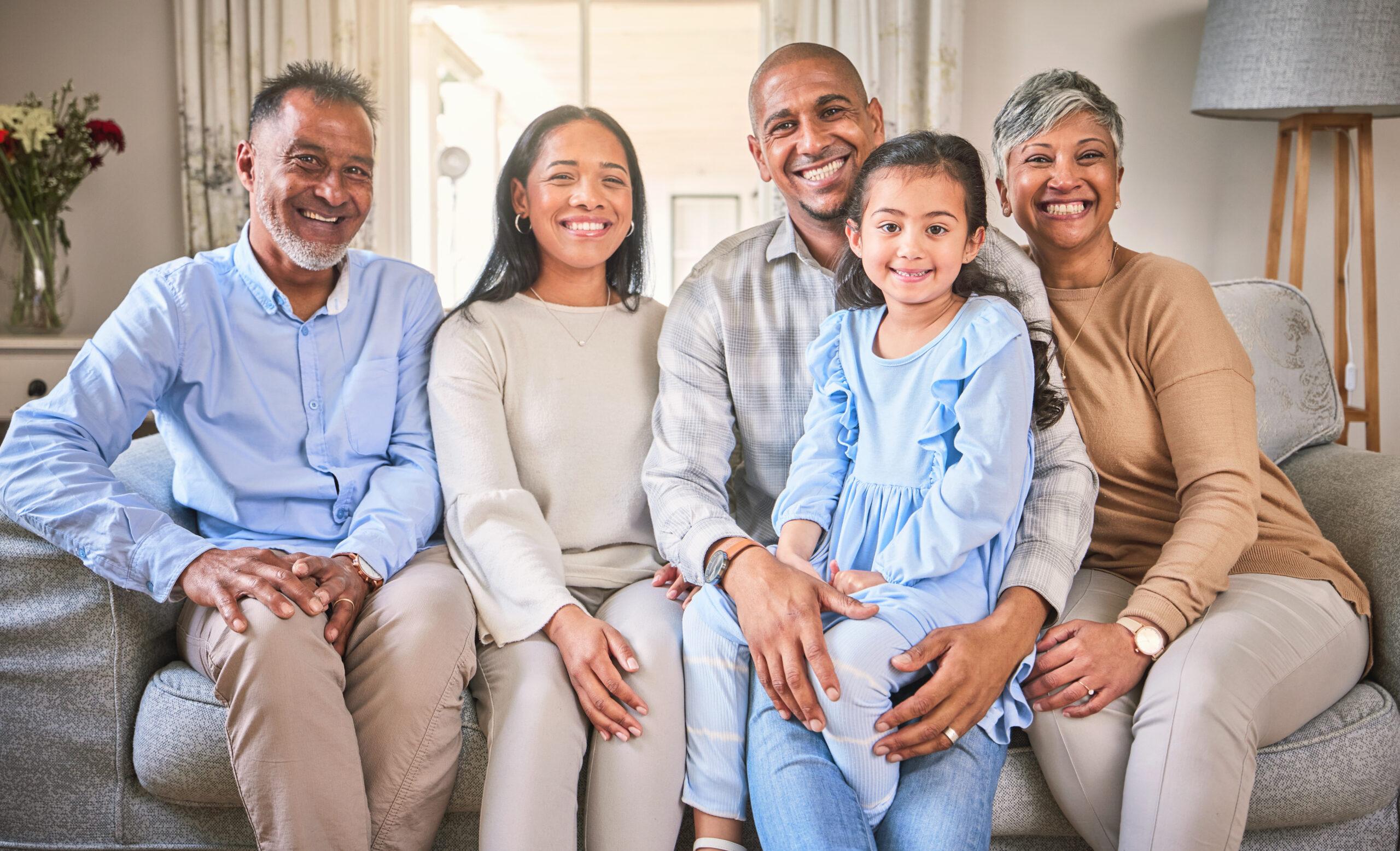 Photo of multigenerational family sitting in living room.