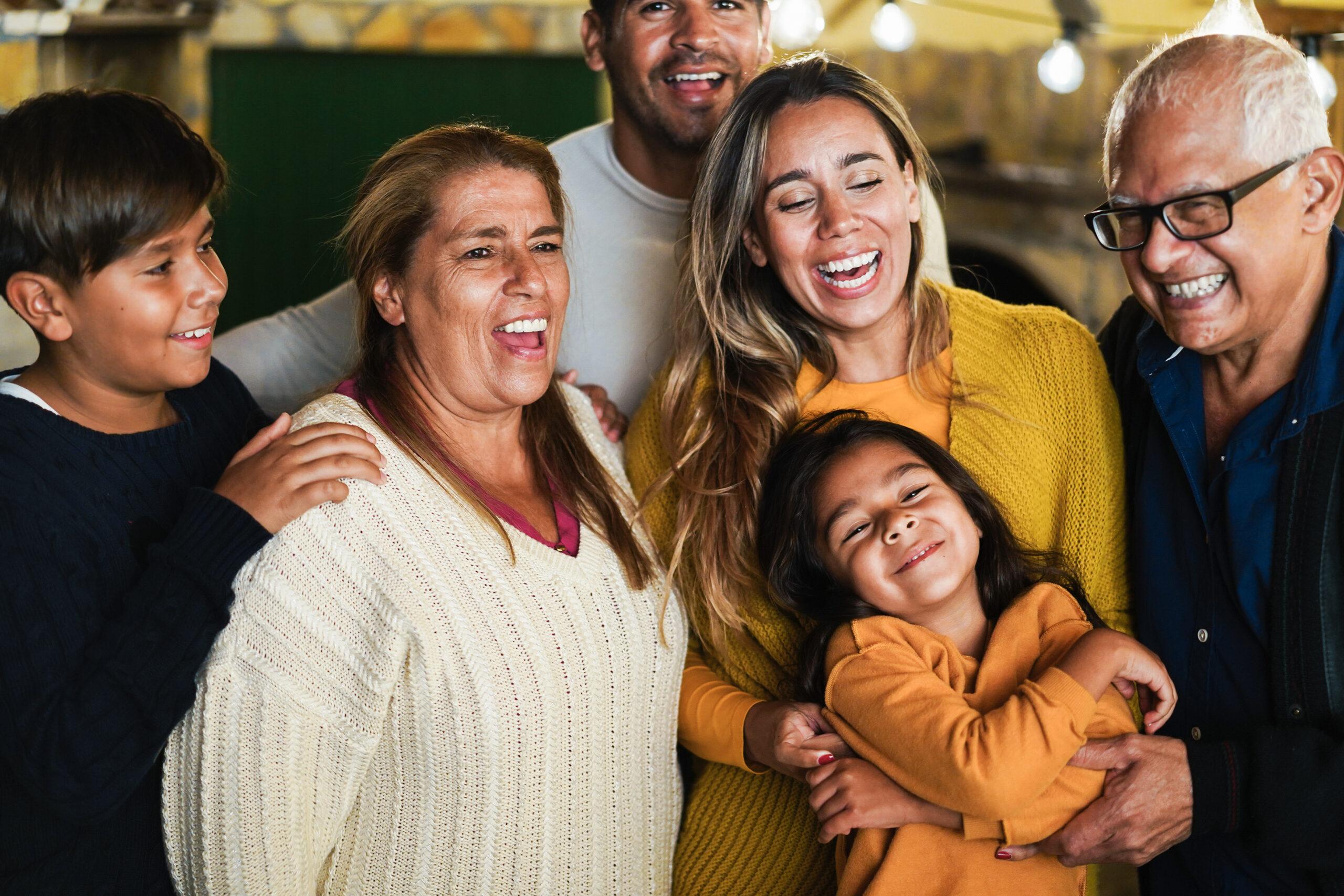 A happy family with children, parents, and grandparents posing together for a photo.