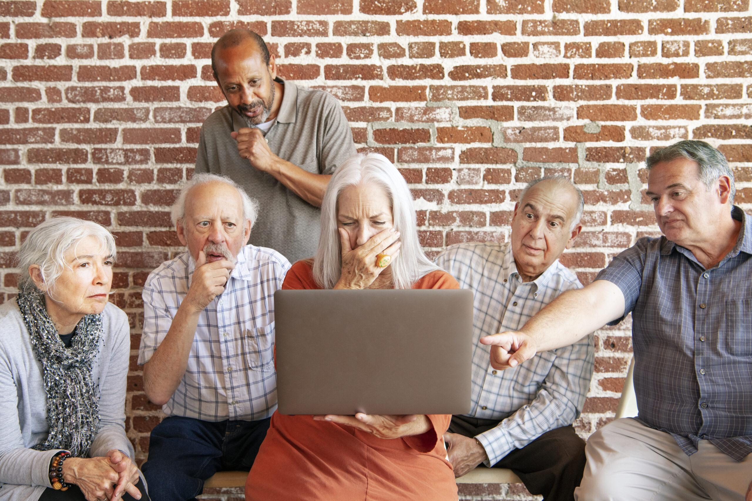 Group of elderly people using a laptop