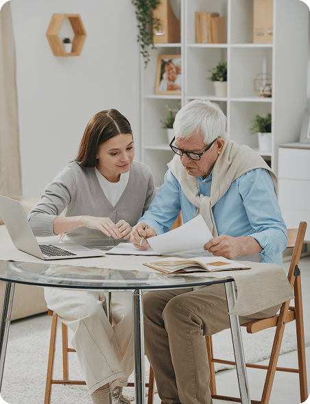 Insurance agent assists senior to fill out paperwork