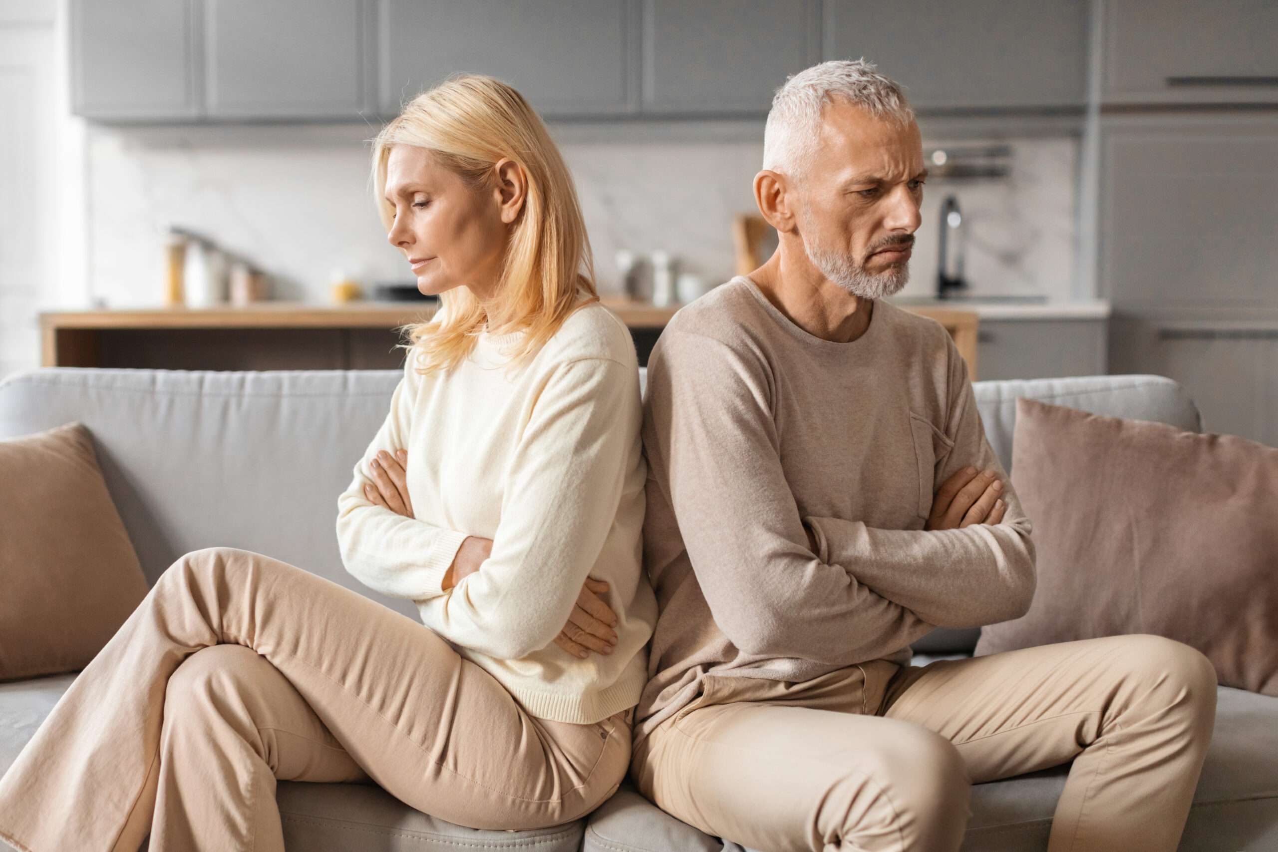 Life insurance and divorce, couple sitting facing away from each other