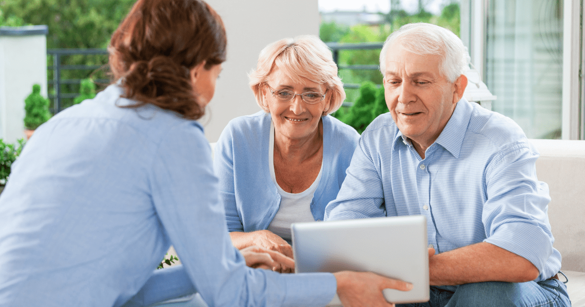 Older couple at table talking with insurance agent