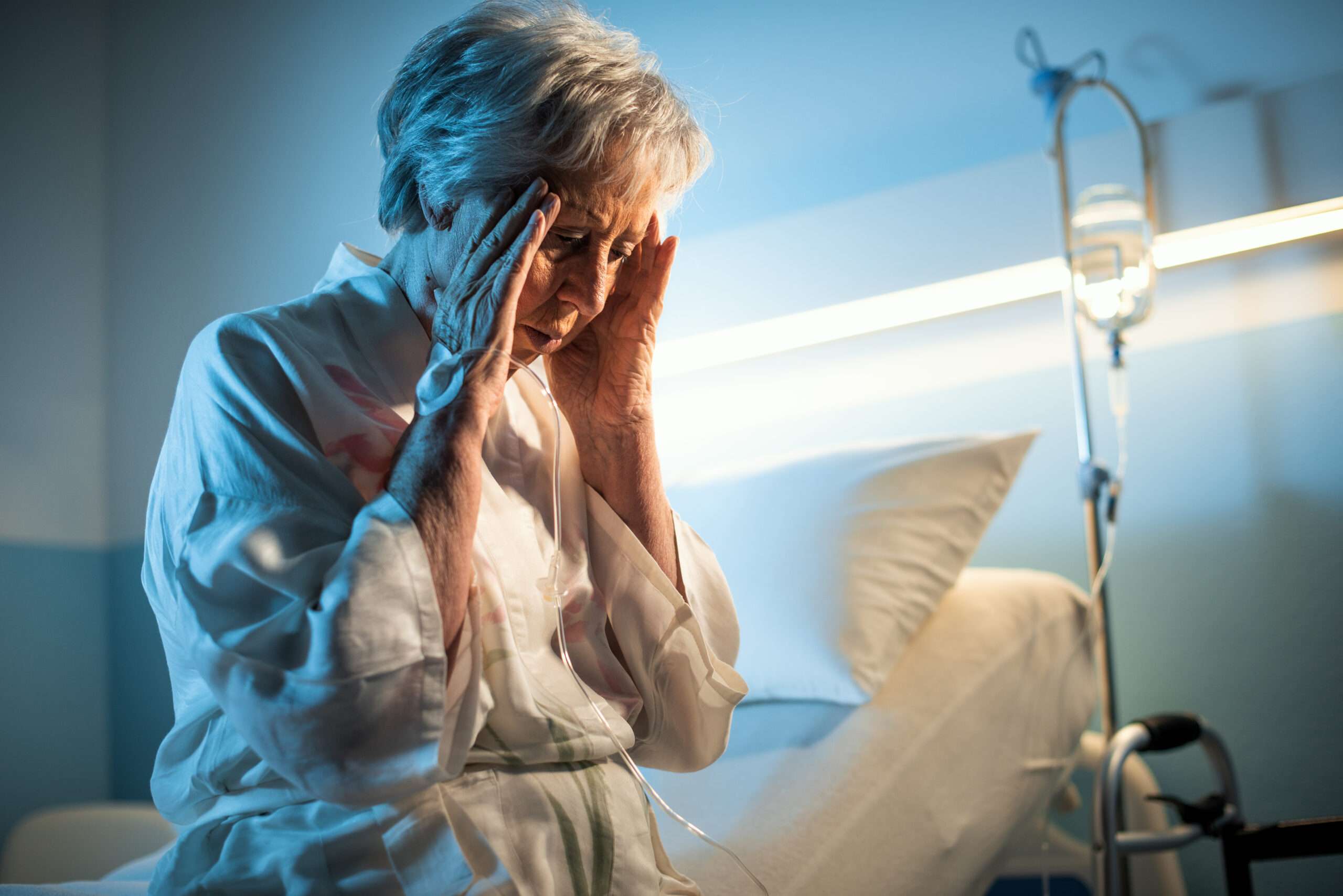 An ill senior woman standing in a hospital room, with text reading "Terminal Illness Life Insurance" and the Final Expense Benefits logo above.