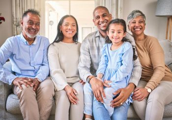 Photo of multigenerational family sitting in living room.