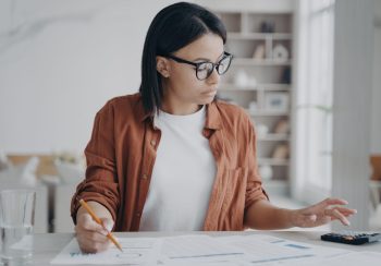 A businesswoman working on finances at home.