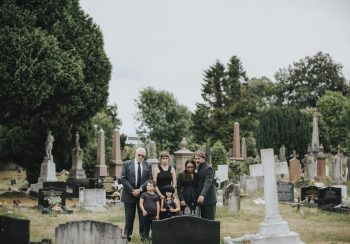 Family giving their last goodbyes at the cemetery