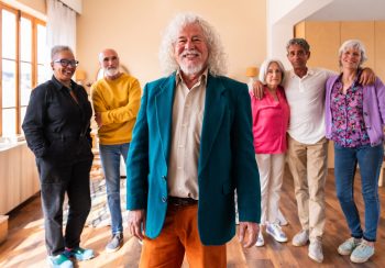 Group of happy senior friends bonding at home for dinner party - Cheerful and youthful old mature multiethnic people having fun
