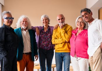 Group of senior friends bonding at home for dinner party