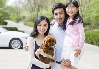 Happy young family with their pet dog