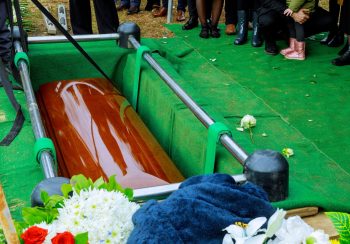 People at funeral putting down the coffin at a funeral