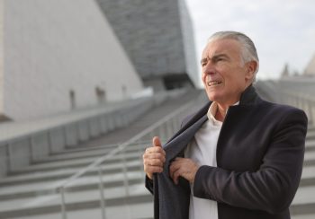 man standing on stairs weighs his options