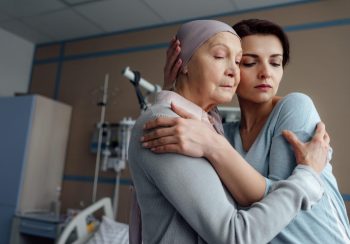 Mother and daughter hugging in hospital